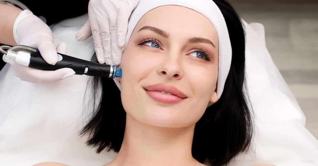 Woman receiving a Hydrafacial treatment on her face (models)
